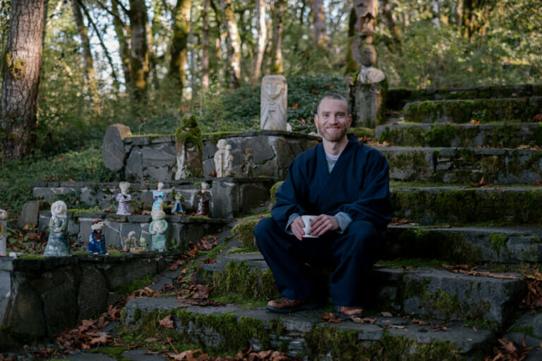 Jogen seated on stone steps