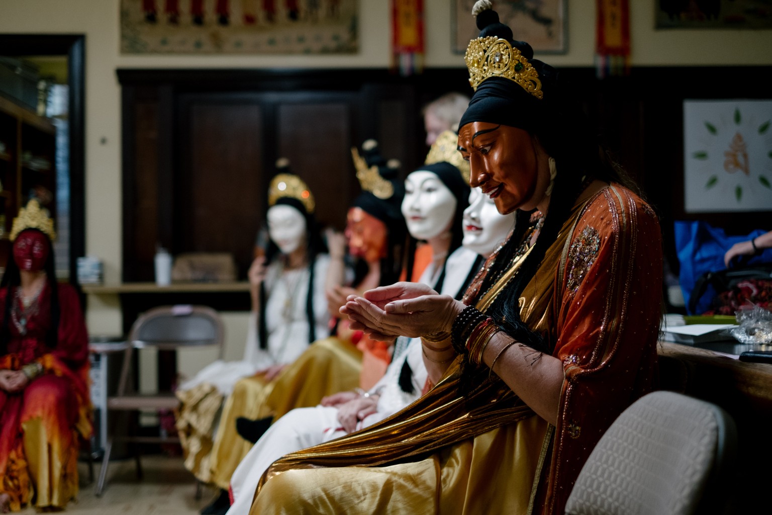 Taradhatu dancers in costume and masks preparing for a ritual dance